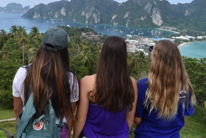 Travelers looking out over a coastal bay